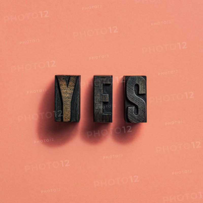 Wooden printer font letters spelling word Yes