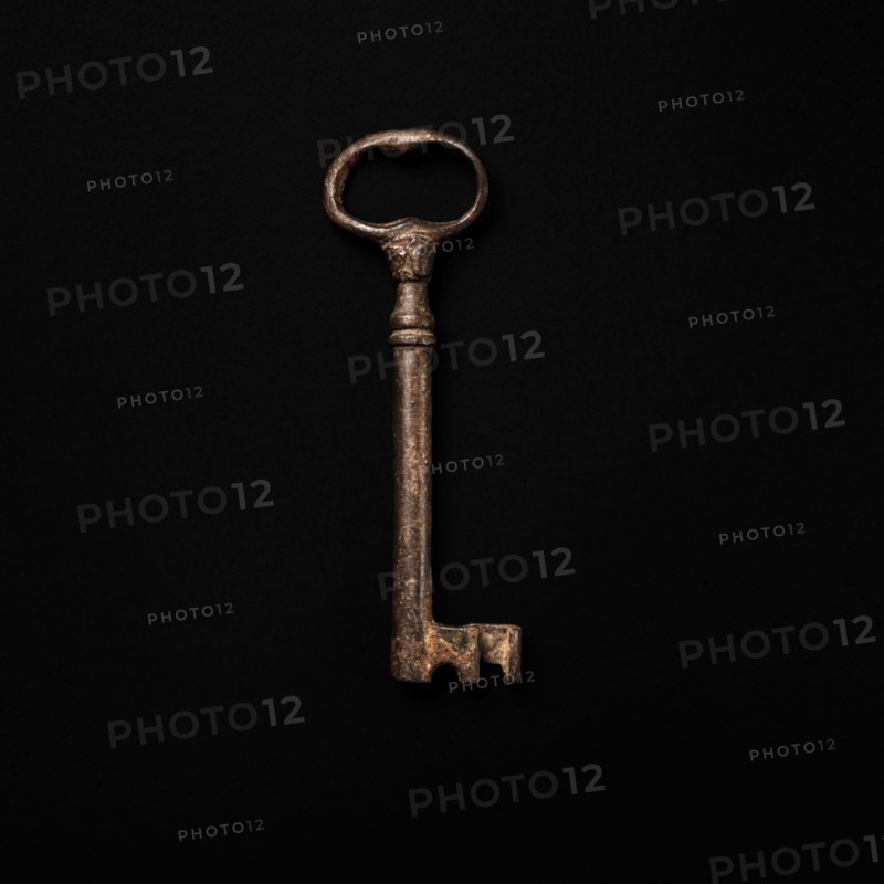Antique key on black background