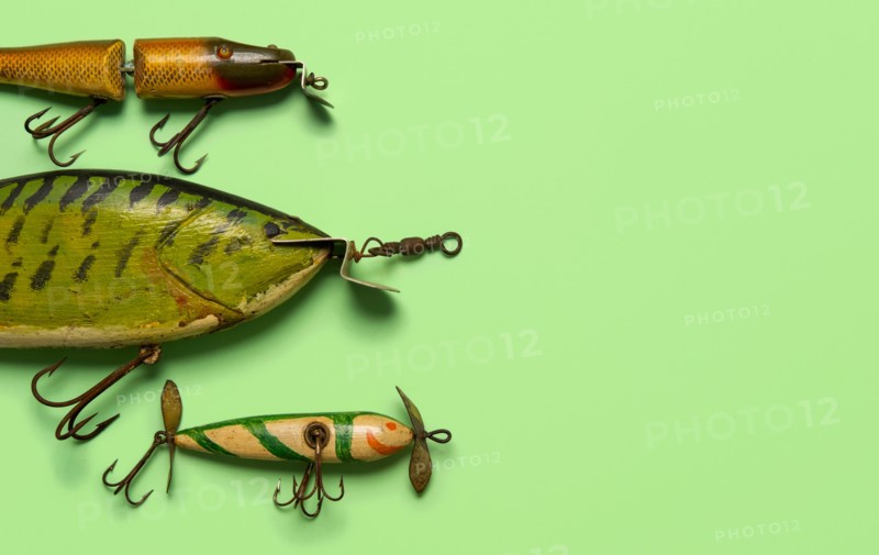 Antique fishing lures on green background