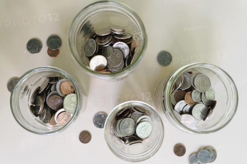 Jars with money on white background