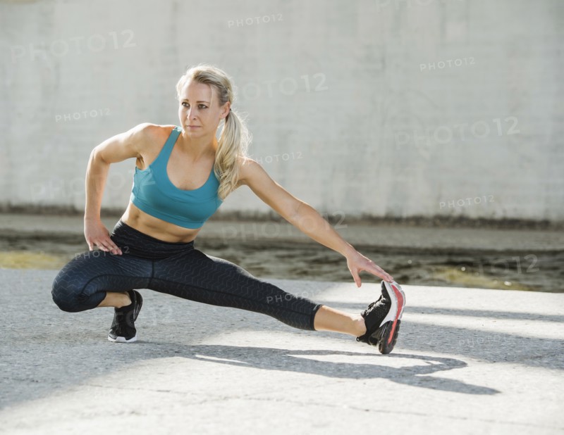 Sporty woman stretching outdoors