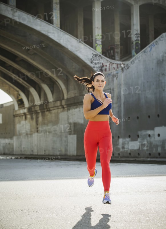 USA, California, Los Angeles, Sporty woman jogging in urban setting