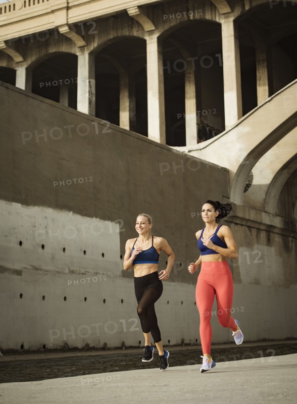 USA, California, Los Angeles, Two sporty women jogging in urban setting