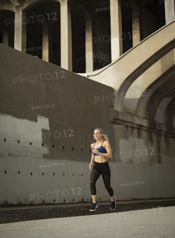 USA, California, Los Angeles, Sporty woman jogging in urban setting