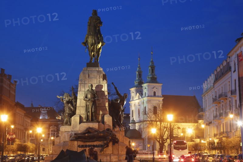 Poland, Lesser Poland, Krakow, Monument with statues on illuminated old town square