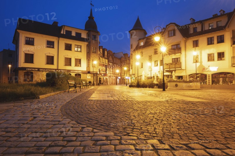 Poland, Pomerania, Lebork, Illuminated town square at night