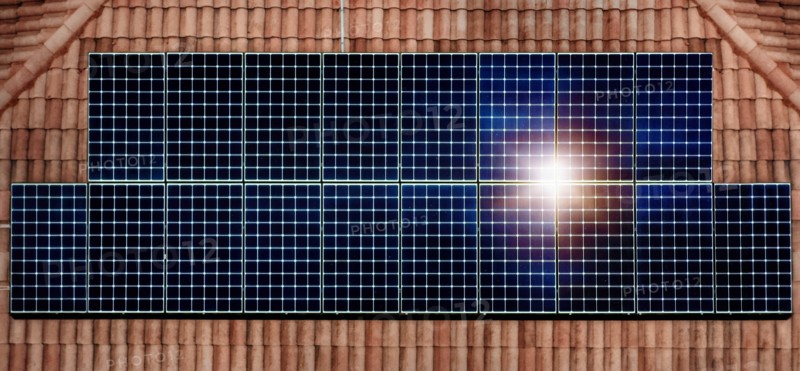 Solar panels reflecting sun on house roof