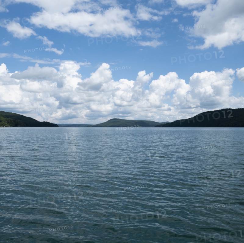 USA, New York, Cooperstown, Otsego Lake, Clouds over lake surrounded by hills