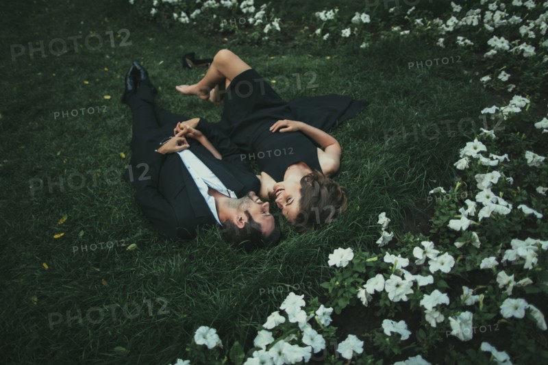 Ukraine, Couple lying down on grass