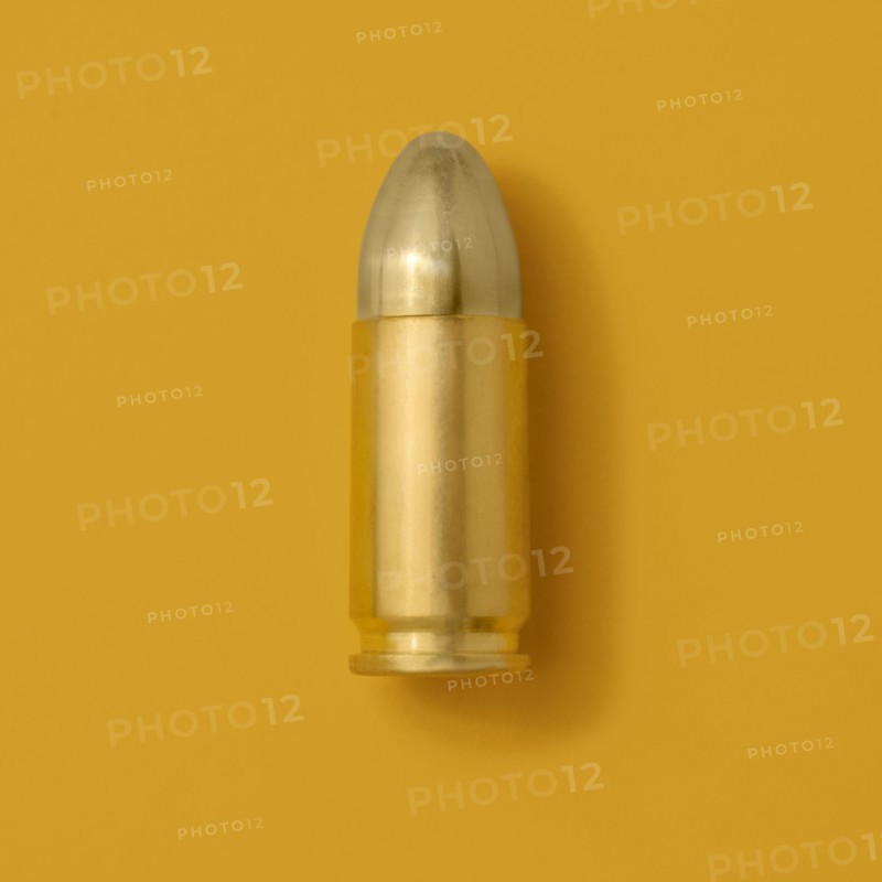 Gold bullet on yellow background
