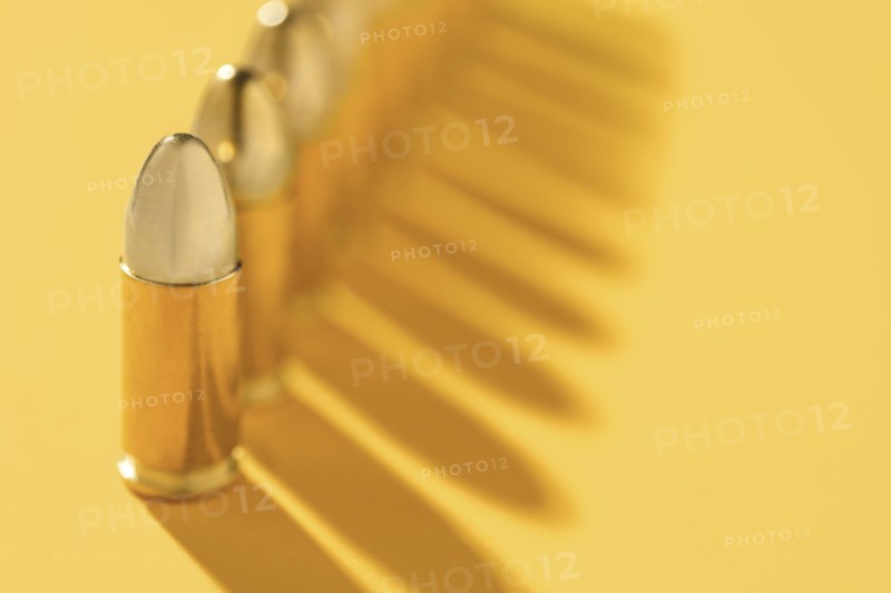 Row of gold bullets on yellow background