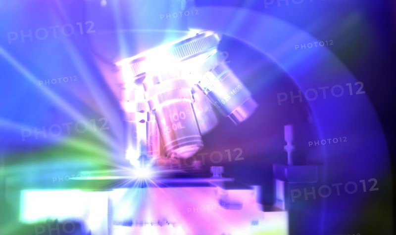 Close-up of microscope lens with abstract light
