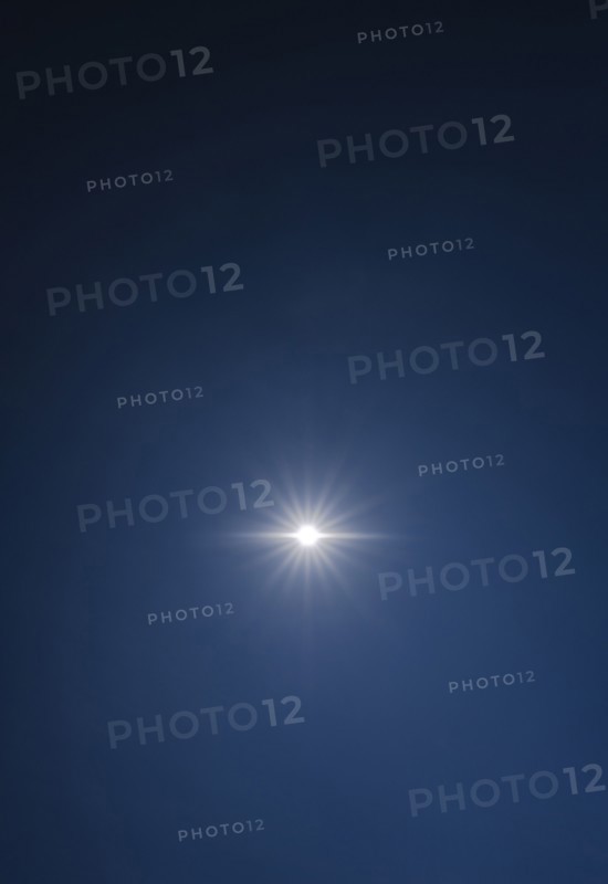 Sun shining on clear blue sky