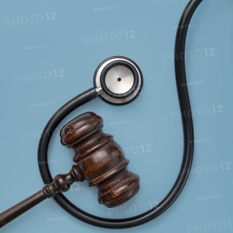 Gavel and stethoscope on blue background