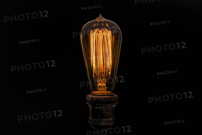 Edison light bulb on black background