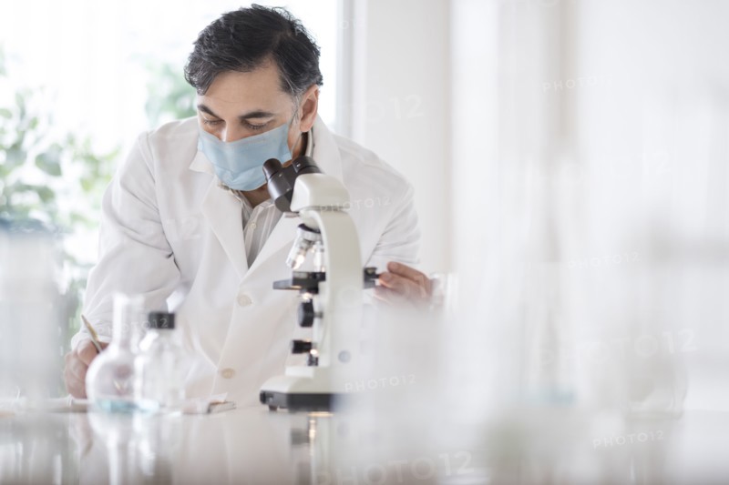 Doctor using microscope