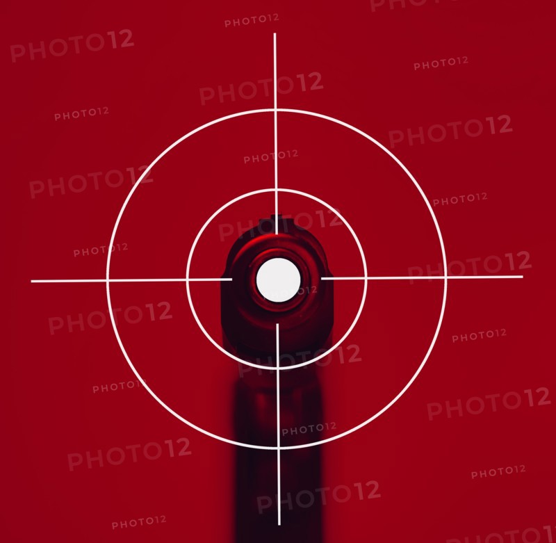 Shooting target on red background with gun