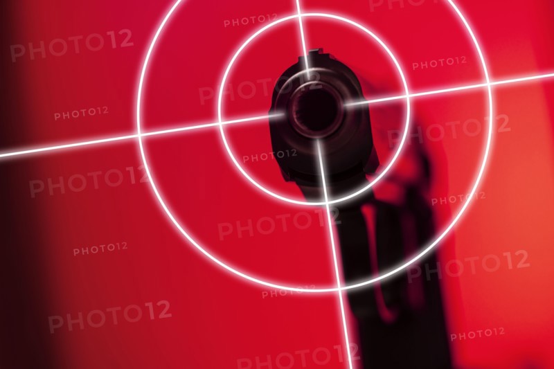 Shooting target on red background with gun