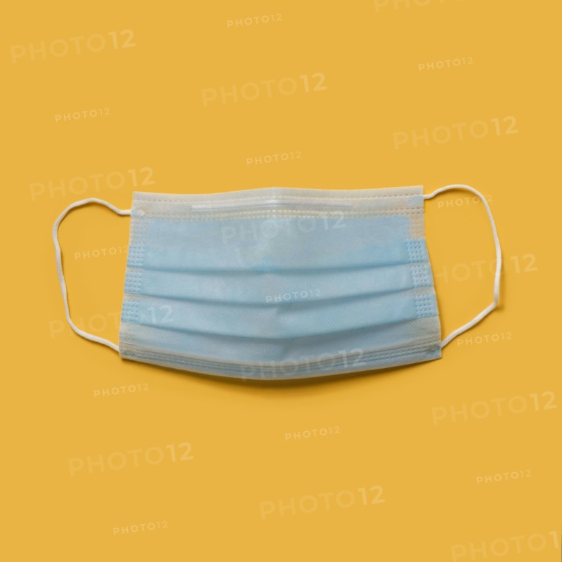 Flu mask on orange background