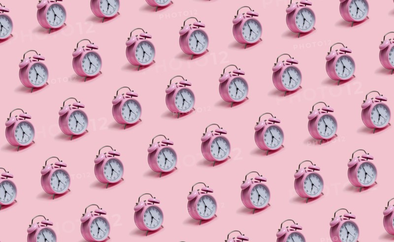Alarm clocks on pink background