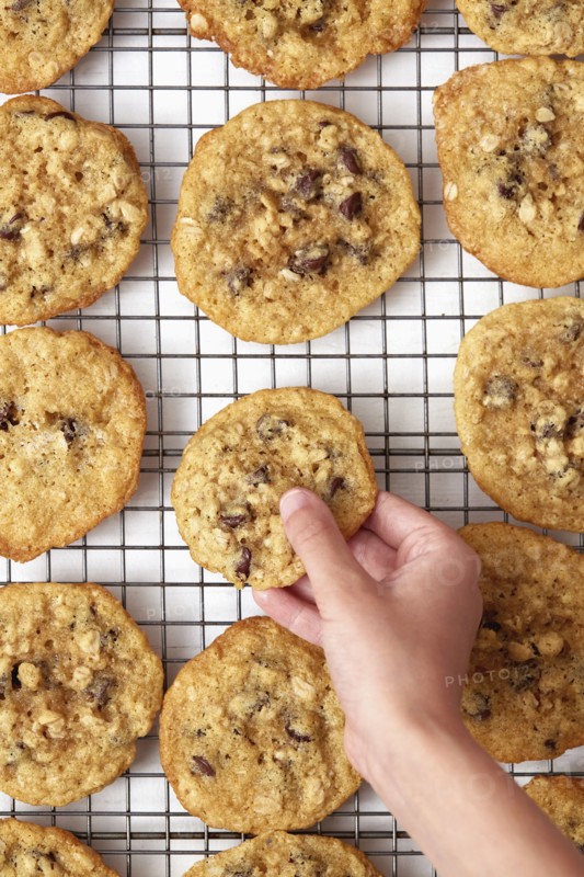 Close-up of girls ( 8-9) hand taking oatmeal cookie