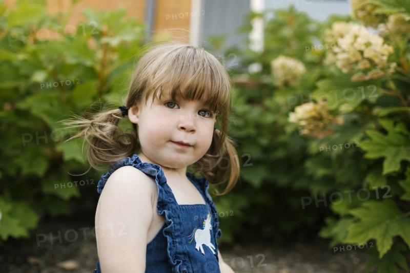 Portrait of toddler girl (2-3) in garden
