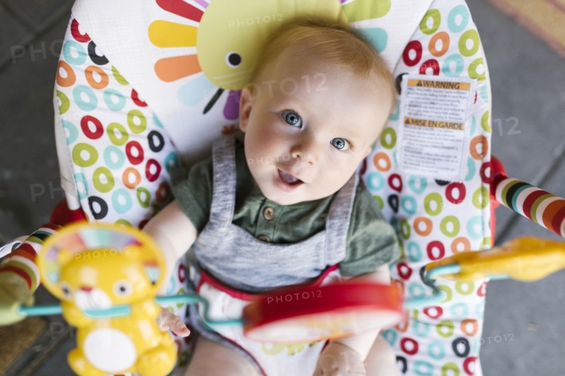 Portrait of baby boy (6-11 months) in baby bouncer