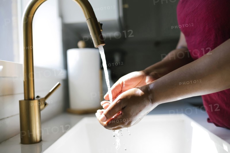 Close-up of woman washing hands in bathroom