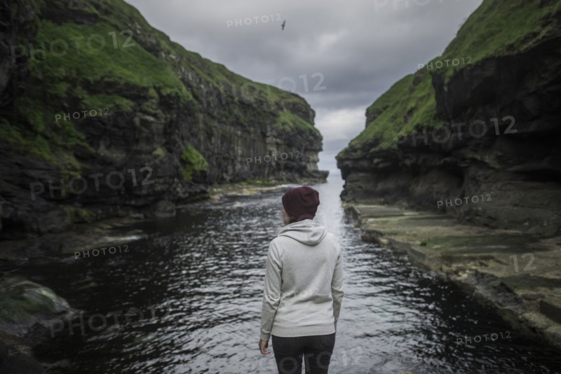 Denmark, Faroe Islands, Gjgv, Woman standing in gorge