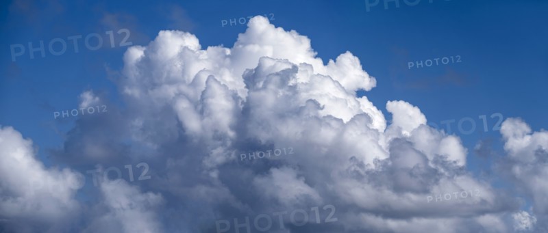 White cumulus clouds on blue sky