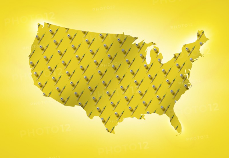 Rows of laboratory vials and syringes on yellow shape of USA