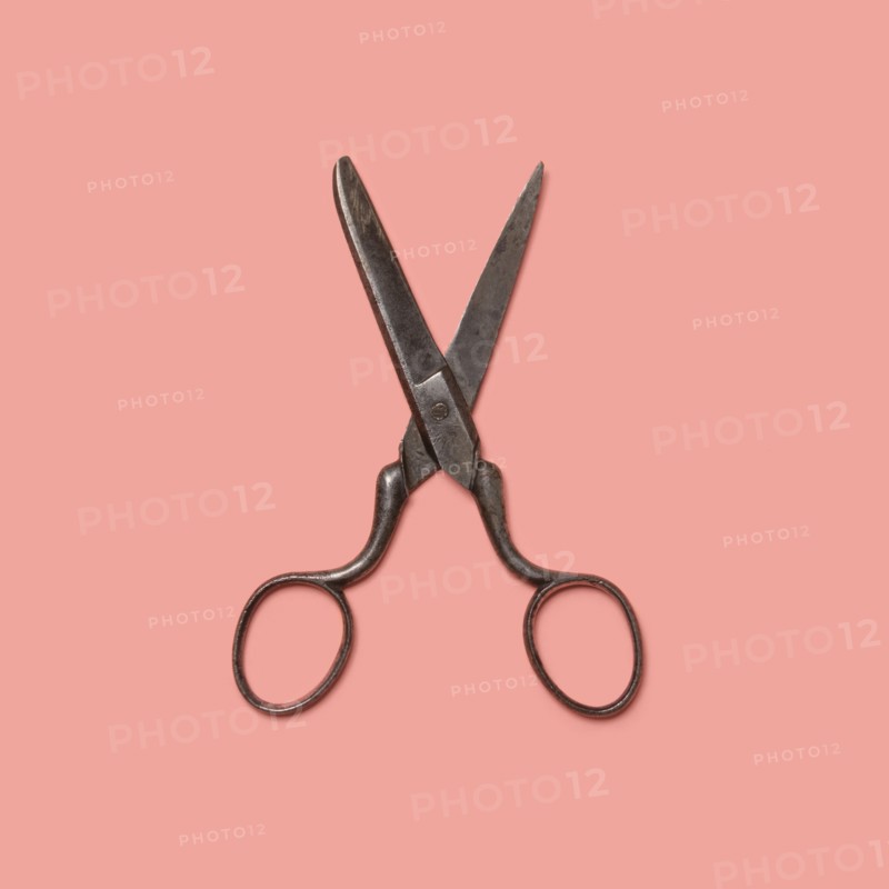 Studio shot of old fashioned scissors on pink background