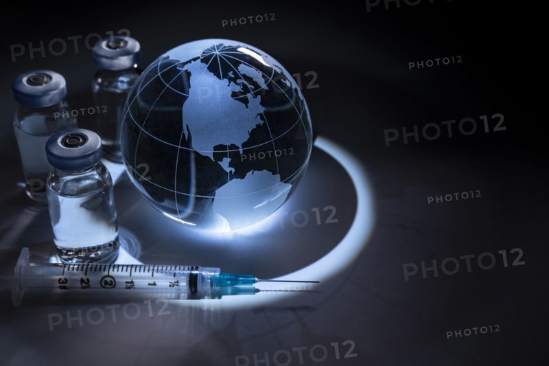Glass globe with vials and syringe