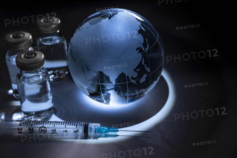 Glass globe with vials and syringe