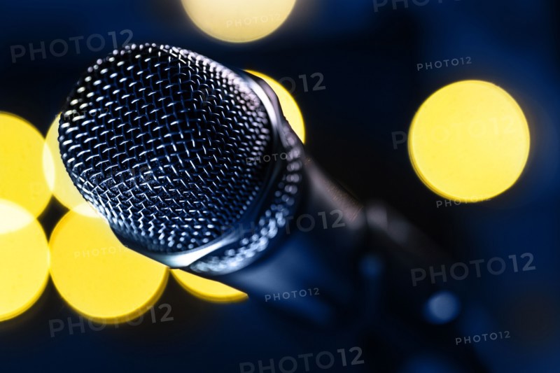 Close-up of microphone and stage lights