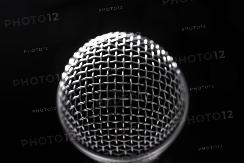 Close-up of microphone and stage lights