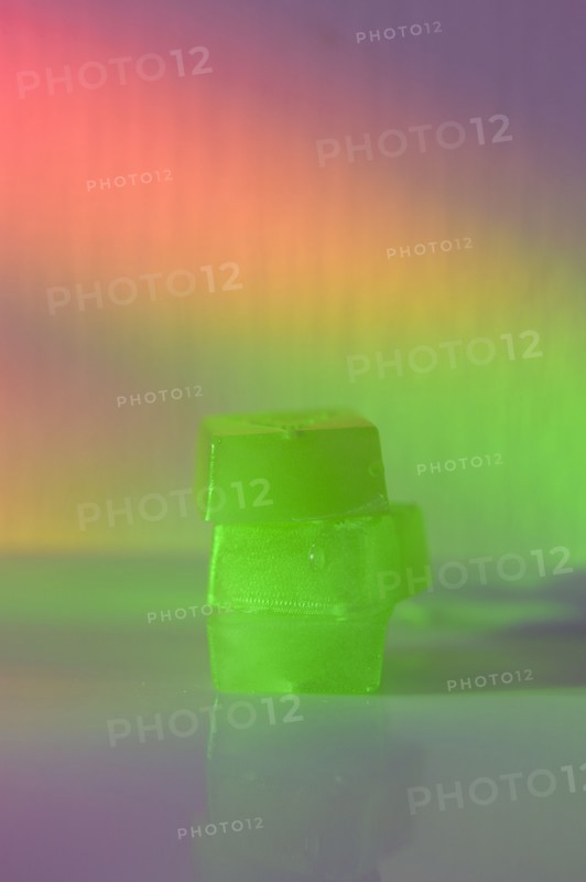 Stack of edible cannabis gummies in rainbow light