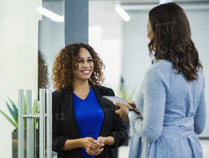 Smiling businesswomen talking in office