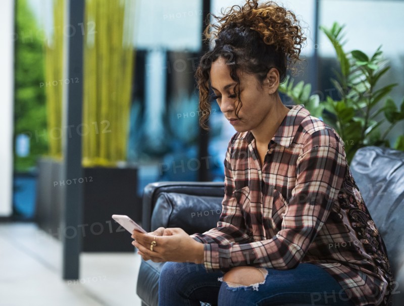 Woman sitting on sofa in office