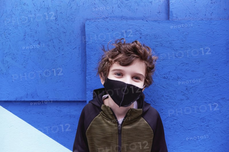 Boy (8-9) wearing protective face mask