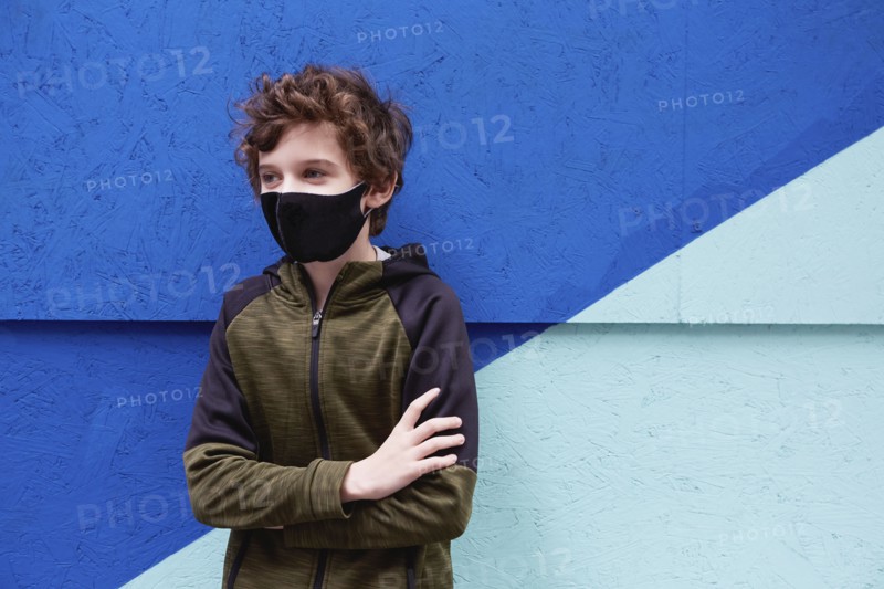 Boy (8-9) wearing protective face mask
