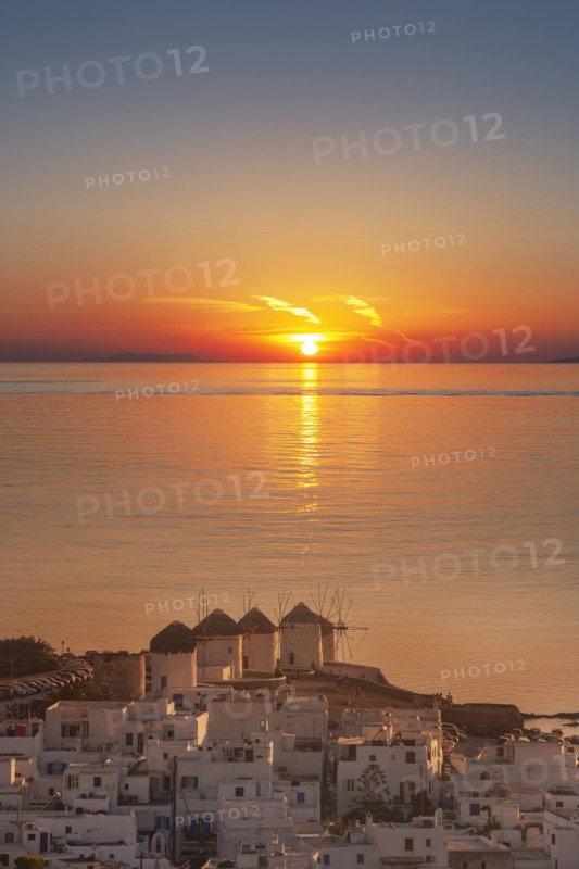Aerial view of sea and coastal town at sunset