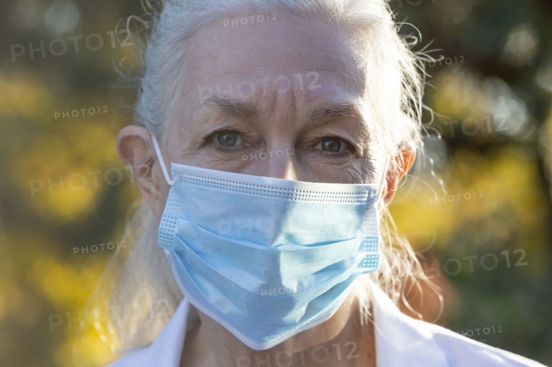 Portrait of senior female medical staff in covid protective mask