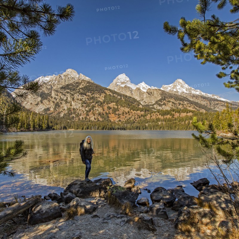 Senior woman standing by Taggart Lake in Grand Teton National Park