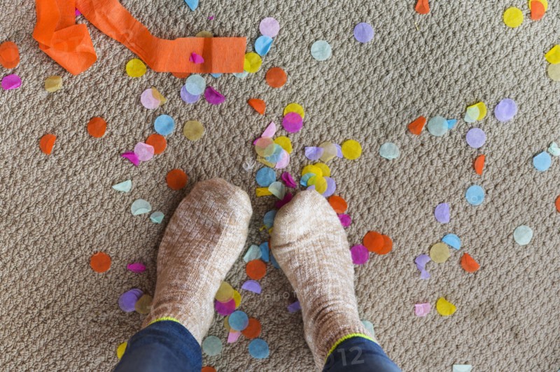 Human feet on floor with confetti