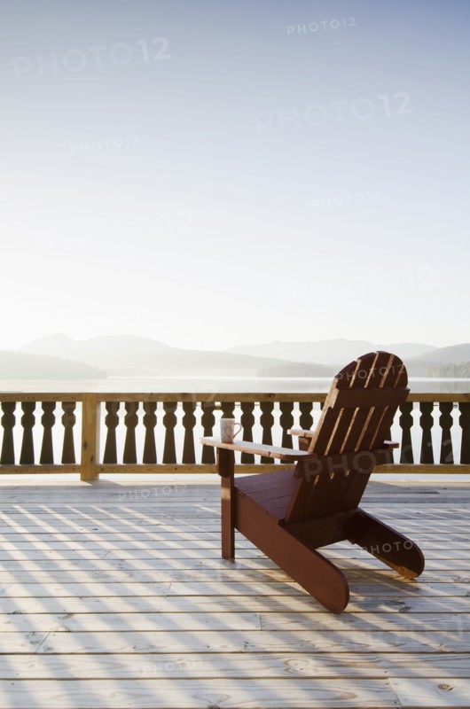 Adirondack chair on deck by lake