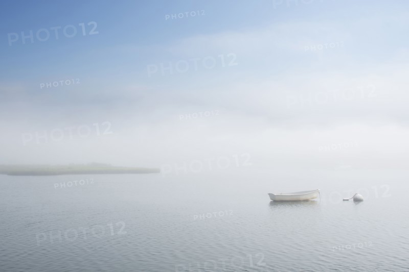 Dinghy on foggy lake