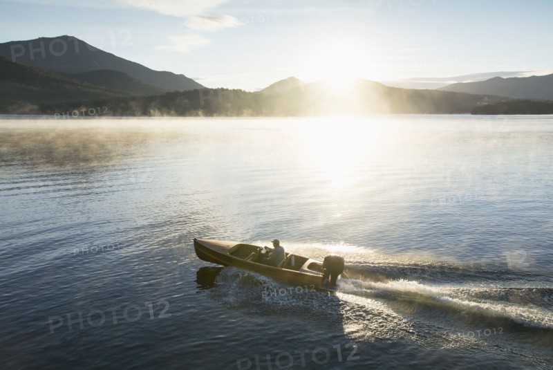 Man in motorboat on Lake Placid