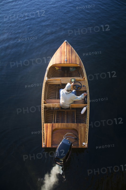 Man in motorboat on Lake Placid