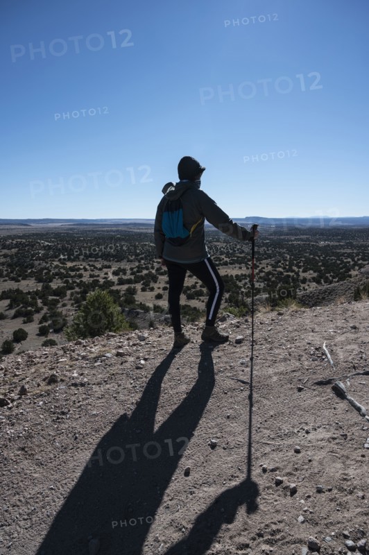 Female hiker looking at Galisteo Basin Preserve